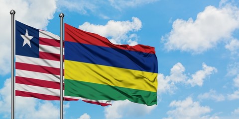 Liberia and Mauritius flag waving in the wind against white cloudy blue sky together. Diplomacy concept, international relations.