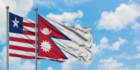 Liberia and Nepal flag waving in the wind against white cloudy blue sky together. Diplomacy concept, international relations.