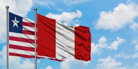 Liberia and Peru flag waving in the wind against white cloudy blue sky together. Diplomacy concept, international relations.
