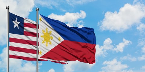 Liberia and Philippines flag waving in the wind against white cloudy blue sky together. Diplomacy concept, international relations.