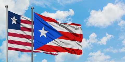 Liberia and Puerto Rico flag waving in the wind against white cloudy blue sky together. Diplomacy concept, international relations.
