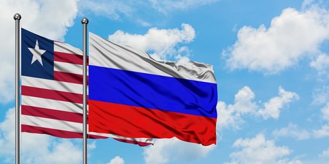 Liberia and Russia flag waving in the wind against white cloudy blue sky together. Diplomacy concept, international relations.