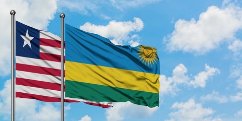 Liberia and Rwanda flag waving in the wind against white cloudy blue sky together. Diplomacy concept, international relations.