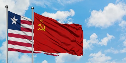 Liberia and Soviet Union flag waving in the wind against white cloudy blue sky together. Diplomacy concept, international relations.