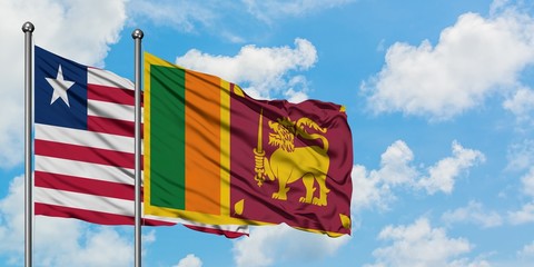 Liberia and Sri Lanka flag waving in the wind against white cloudy blue sky together. Diplomacy concept, international relations.