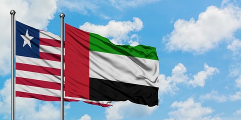 Liberia and United Arab Emirates flag waving in the wind against white cloudy blue sky together. Diplomacy concept, international relations.