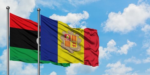 Libya and Andorra flag waving in the wind against white cloudy blue sky together. Diplomacy concept, international relations.