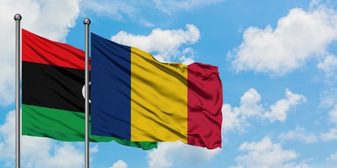 Libya and Chad flag waving in the wind against white cloudy blue sky together. Diplomacy concept, international relations.