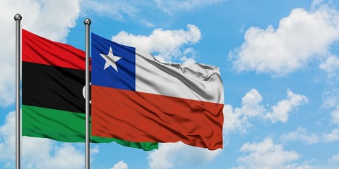 Libya and Chile flag waving in the wind against white cloudy blue sky together. Diplomacy concept, international relations.