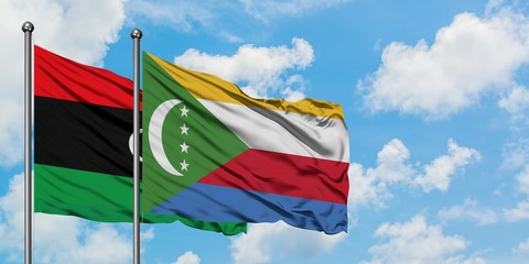 Libya and Comoros flag waving in the wind against white cloudy blue sky together. Diplomacy concept, international relations.