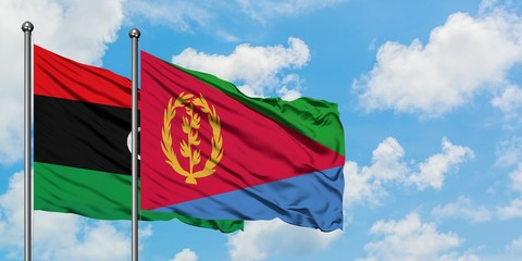 Libya and Eritrea flag waving in the wind against white cloudy blue sky together. Diplomacy concept, international relations.