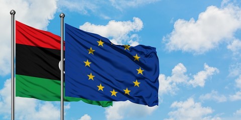 Libya and European Union flag waving in the wind against white cloudy blue sky together. Diplomacy concept, international relations.