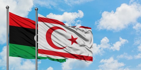 Libya and Northern Cyprus flag waving in the wind against white cloudy blue sky together. Diplomacy concept, international relations.