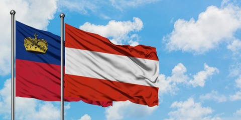 Liechtenstein and Austria flag waving in the wind against white cloudy blue sky together. Diplomacy concept, international relations.