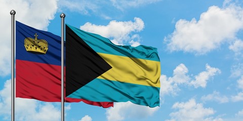 Liechtenstein and Bahamas flag waving in the wind against white cloudy blue sky together. Diplomacy concept, international relations.