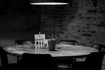 Reserved wooden round table in a brick wall pub