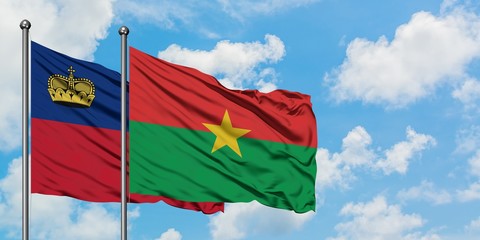 Liechtenstein and Burkina Faso flag waving in the wind against white cloudy blue sky together. Diplomacy concept, international relations.