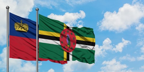 Liechtenstein and Dominica flag waving in the wind against white cloudy blue sky together. Diplomacy concept, international relations.