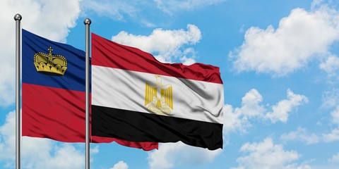 Liechtenstein and Egypt flag waving in the wind against white cloudy blue sky together. Diplomacy concept, international relations.