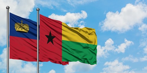 Liechtenstein and Guinea Bissau flag waving in the wind against white cloudy blue sky together. Diplomacy concept, international relations.