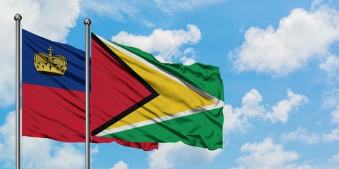 Liechtenstein and Guyana flag waving in the wind against white cloudy blue sky together. Diplomacy concept, international relations.