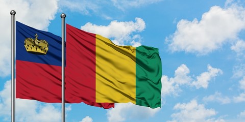Liechtenstein and Guinea flag waving in the wind against white cloudy blue sky together. Diplomacy concept, international relations.
