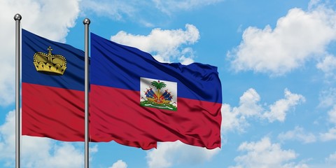 Liechtenstein and Haiti flag waving in the wind against white cloudy blue sky together. Diplomacy...