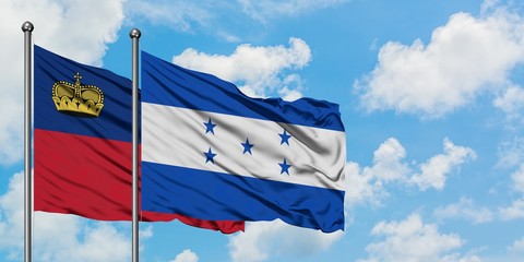 Liechtenstein and Honduras flag waving in the wind against white cloudy blue sky together. Diplomacy concept, international relations.