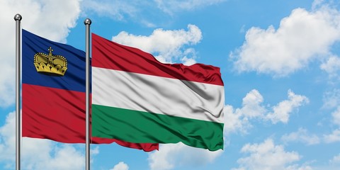 Liechtenstein and Hungary flag waving in the wind against white cloudy blue sky together. Diplomacy concept, international relations.