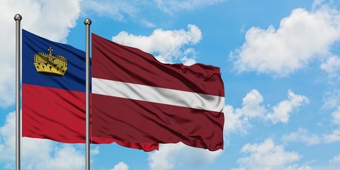 Liechtenstein and Latvia flag waving in the wind against white cloudy blue sky together. Diplomacy concept, international relations.