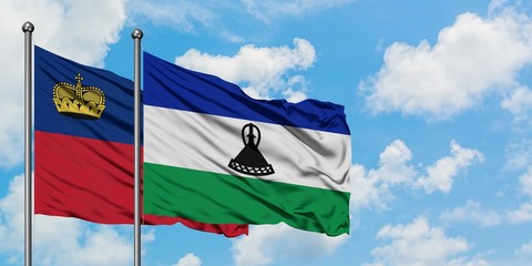 Liechtenstein and Lesotho flag waving in the wind against white cloudy blue sky together. Diplomacy concept, international relations.