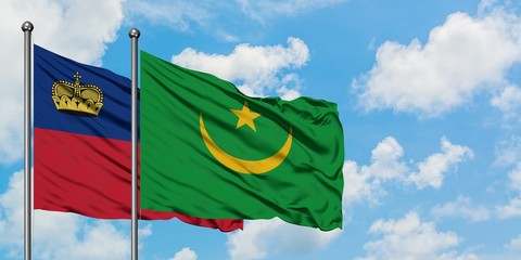 Liechtenstein and Mauritania flag waving in the wind against white cloudy blue sky together. Diplomacy concept, international relations.