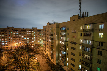 Typical soviet yard with multistorey apartment in evening.