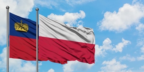 Liechtenstein and Poland flag waving in the wind against white cloudy blue sky together. Diplomacy concept, international relations.