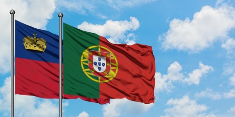 Liechtenstein and Portugal flag waving in the wind against white cloudy blue sky together. Diplomacy concept, international relations.