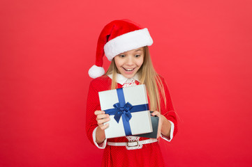 Winter holidays. Gift from Santa. Winter season. Fun time of year that you can easily tackle in a fun and organized manner. Little girl with christmas gift. Shopping concept. Winter tradition
