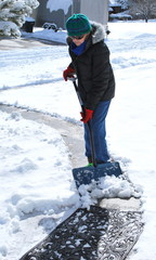Fototapeta na wymiar Mature female shoveling snow outdoors.