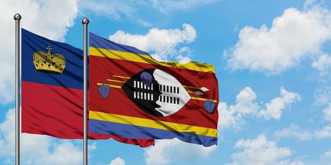 Liechtenstein and Swaziland flag waving in the wind against white cloudy blue sky together. Diplomacy concept, international relations.