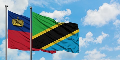 Liechtenstein and Tanzania flag waving in the wind against white cloudy blue sky together. Diplomacy concept, international relations.