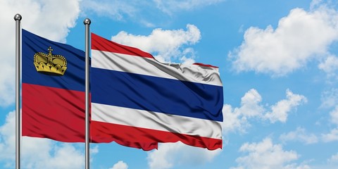 Liechtenstein and Thailand flag waving in the wind against white cloudy blue sky together. Diplomacy concept, international relations.