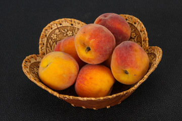 Peach heap in the wooden basket