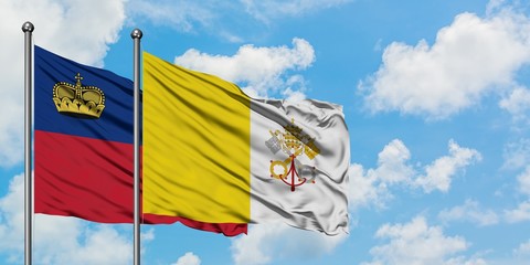 Liechtenstein and Vatican City flag waving in the wind against white cloudy blue sky together. Diplomacy concept, international relations.