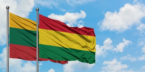 Lithuania and Bolivia flag waving in the wind against white cloudy blue sky together. Diplomacy concept, international relations.