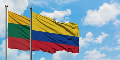 Lithuania and Colombia flag waving in the wind against white cloudy blue sky together. Diplomacy concept, international relations.