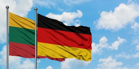 Lithuania and Germany flag waving in the wind against white cloudy blue sky together. Diplomacy concept, international relations.