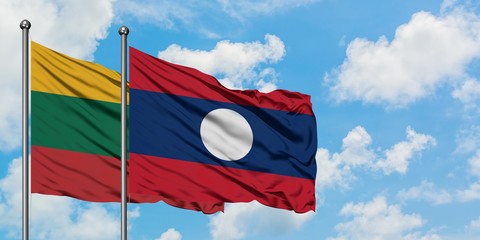 Lithuania and Laos flag waving in the wind against white cloudy blue sky together. Diplomacy concept, international relations.