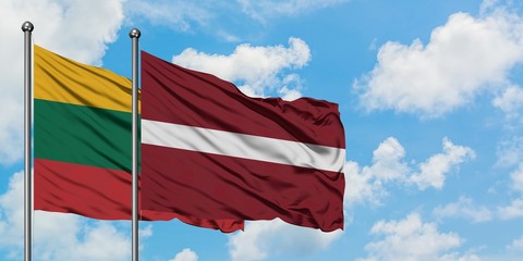 Lithuania and Latvia flag waving in the wind against white cloudy blue sky together. Diplomacy concept, international relations.