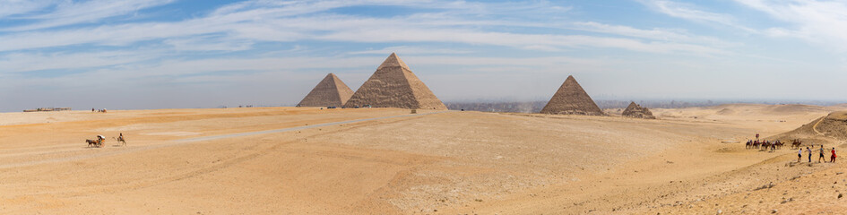 Fototapeta na wymiar The ancient Egyptian Pyramid of Khufu with ruins, tombs and monuments in Giza, Cairo, Egypt