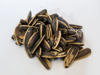 Closeup of black sunflower seeds isolated on white background.
