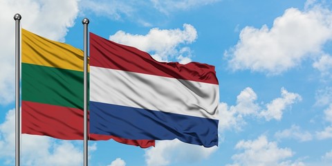 Lithuania and Netherlands flag waving in the wind against white cloudy blue sky together. Diplomacy concept, international relations.